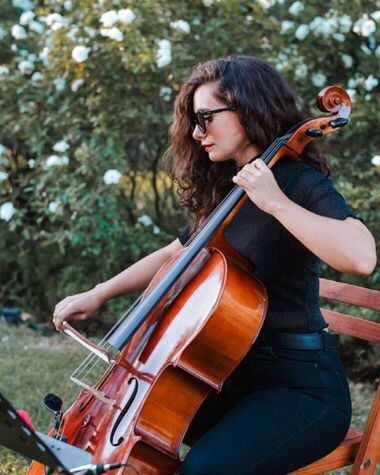 Violonchelista de Tempo Urbano tocando al aire libre en un jardín